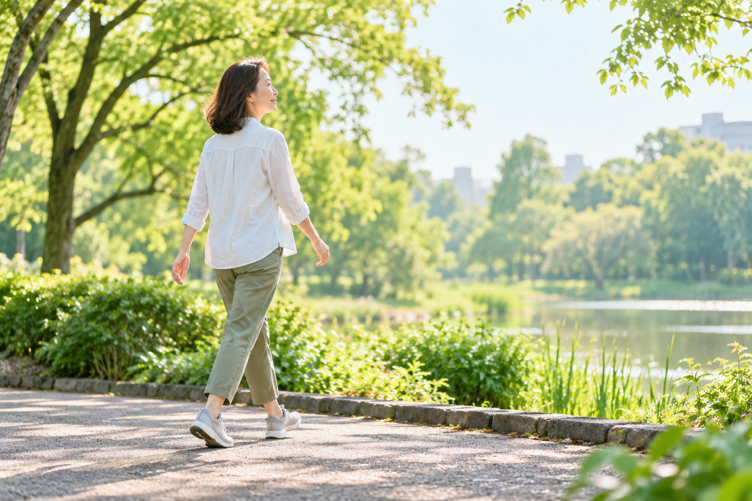 公園を歩きながら姿勢と歩き方を見直す40代女性のイメージ